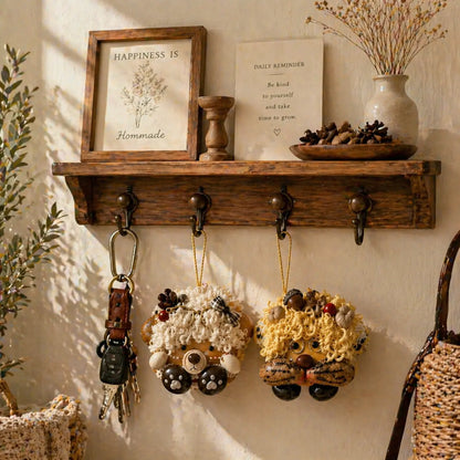 Handmade plush bear and lion keychains hanging on a vintage wooden entryway shelf for cottagecore home decor.